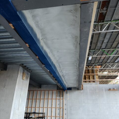 Close view of closed-cell spray foam installed beneath a soffit