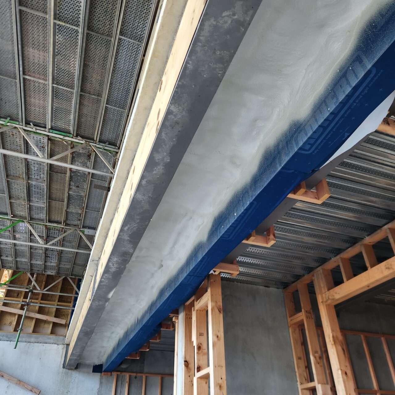 Closed-cell spray foam insulation completed beneath a large soffit