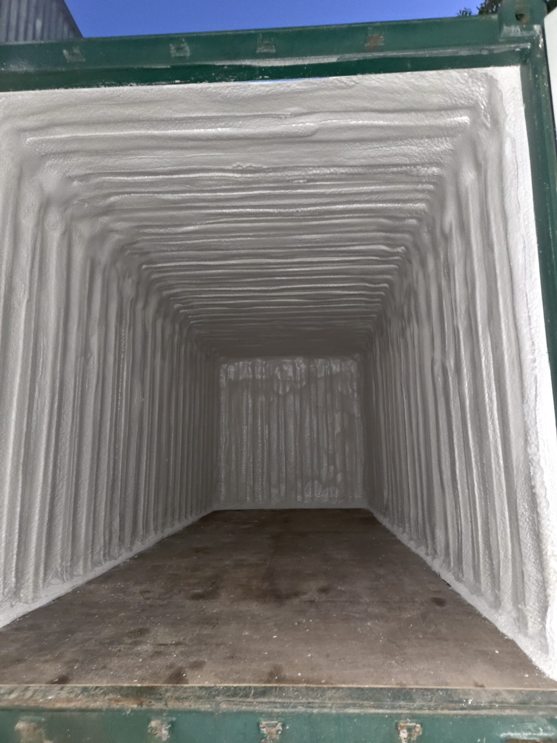 Container interior with completed spray foam insulation