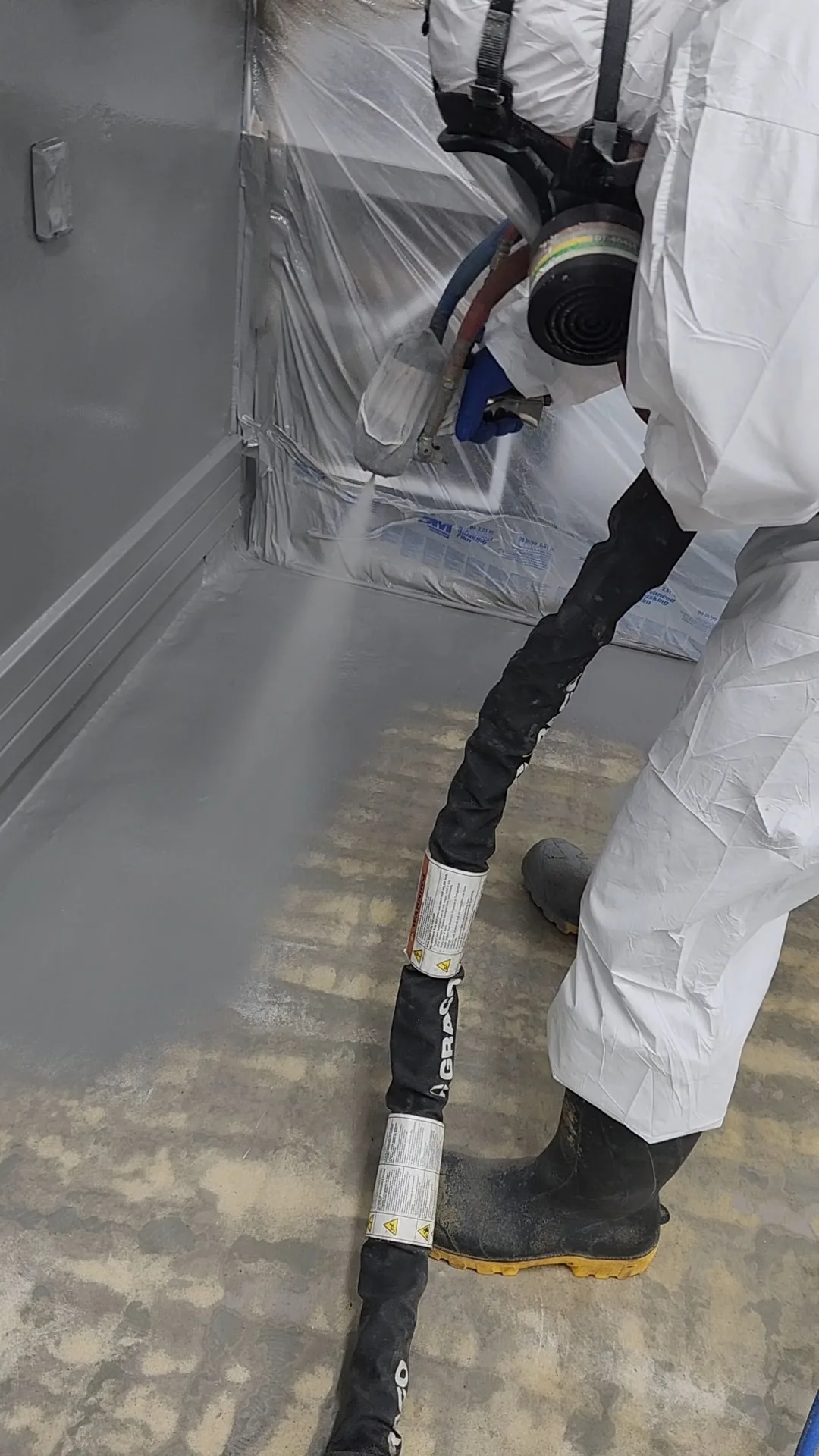 Hot-applied polyurea being sprayed to a commercial kitchen floor