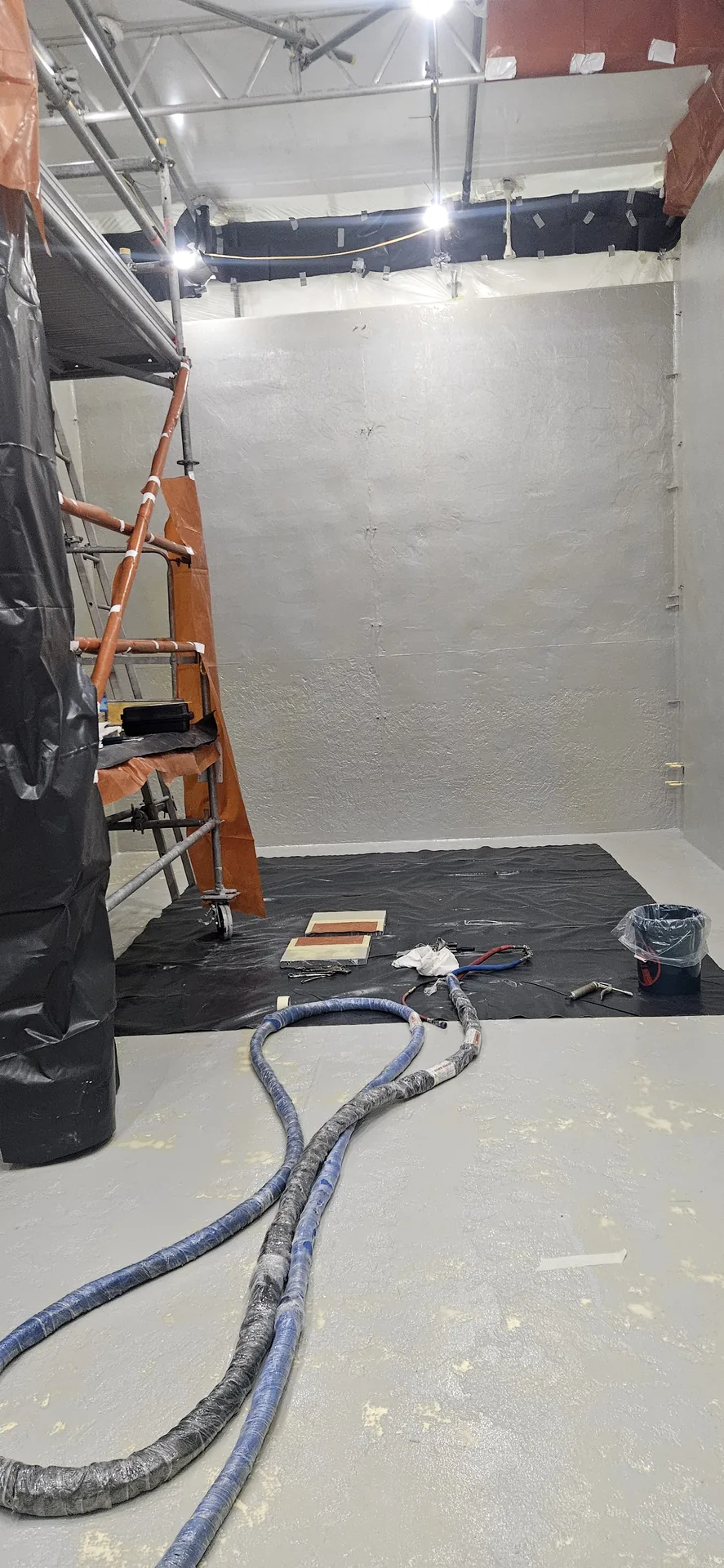 Polyurea spray area prepared with access, lighting and containment