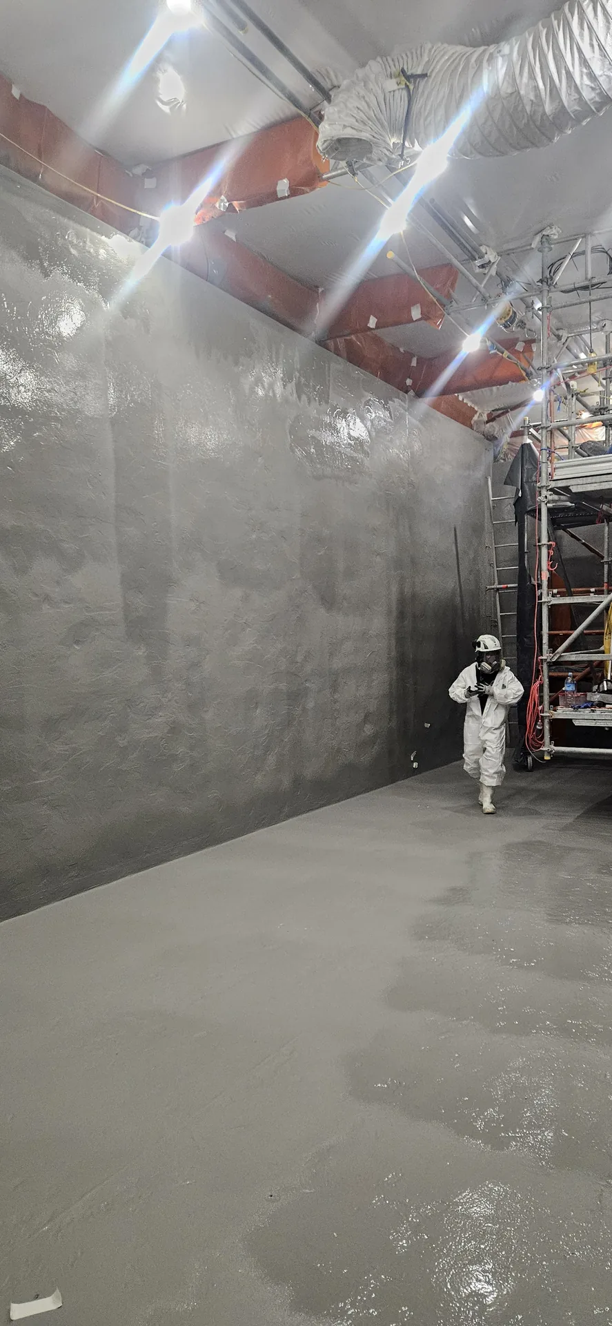 Polyurea lining applied to industrial tank walls and floor
