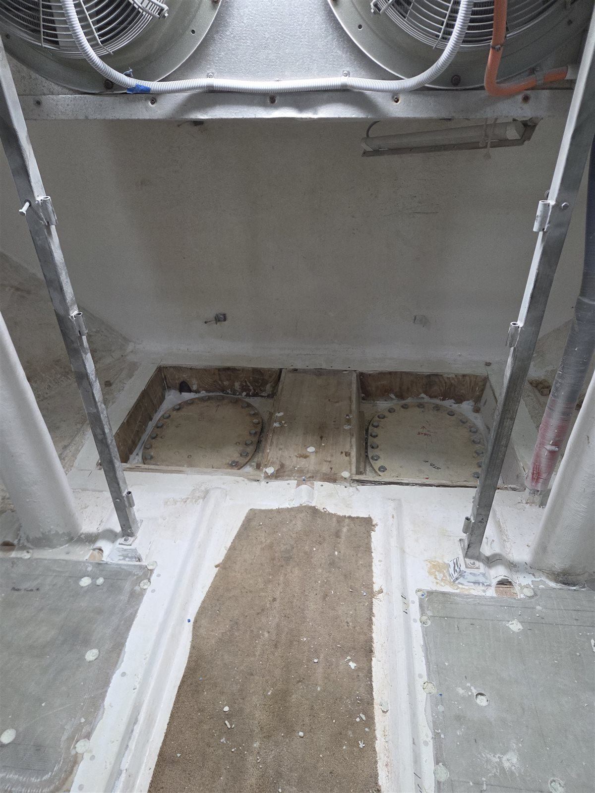 Commercial fishing vessel fish hold during floor cavity injection foam work