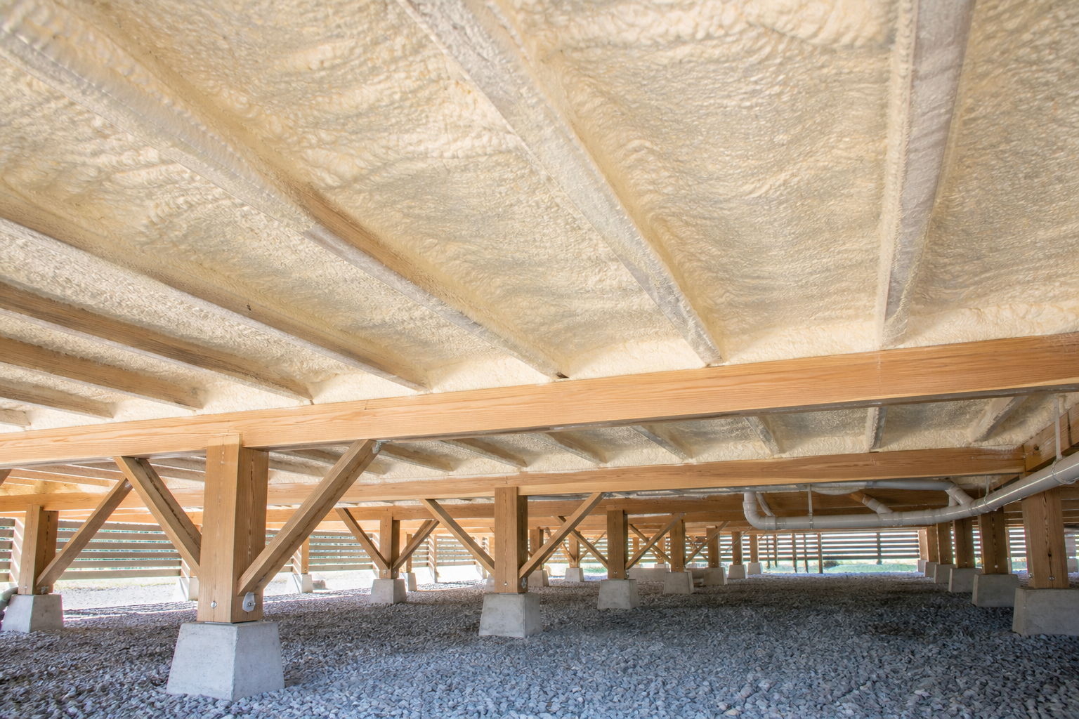 Closed-cell spray foam insulation installed beneath a raised timber floor